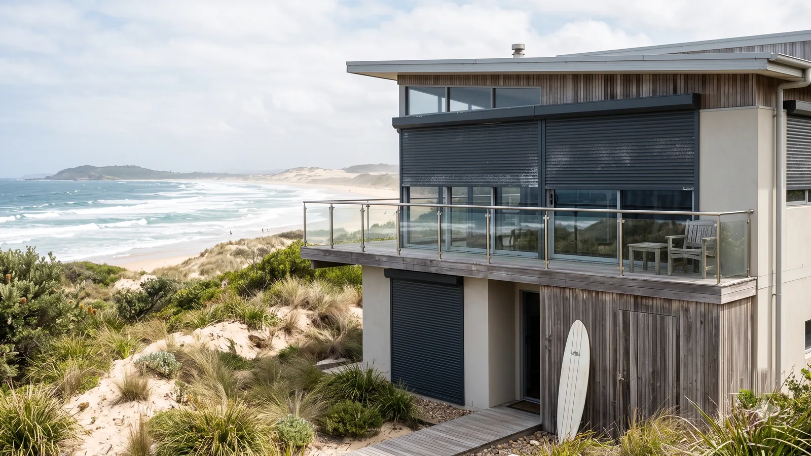 Coastal Australian home with aluminium roller shutters overlooking the ocean and dunes